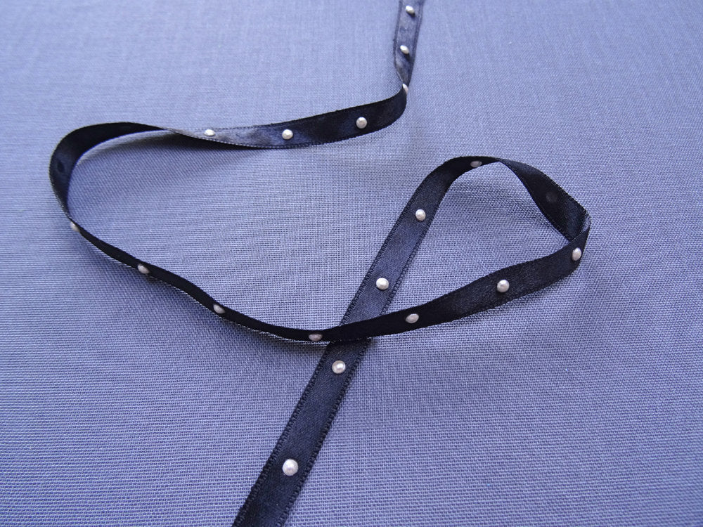 Black ribbon with pearls